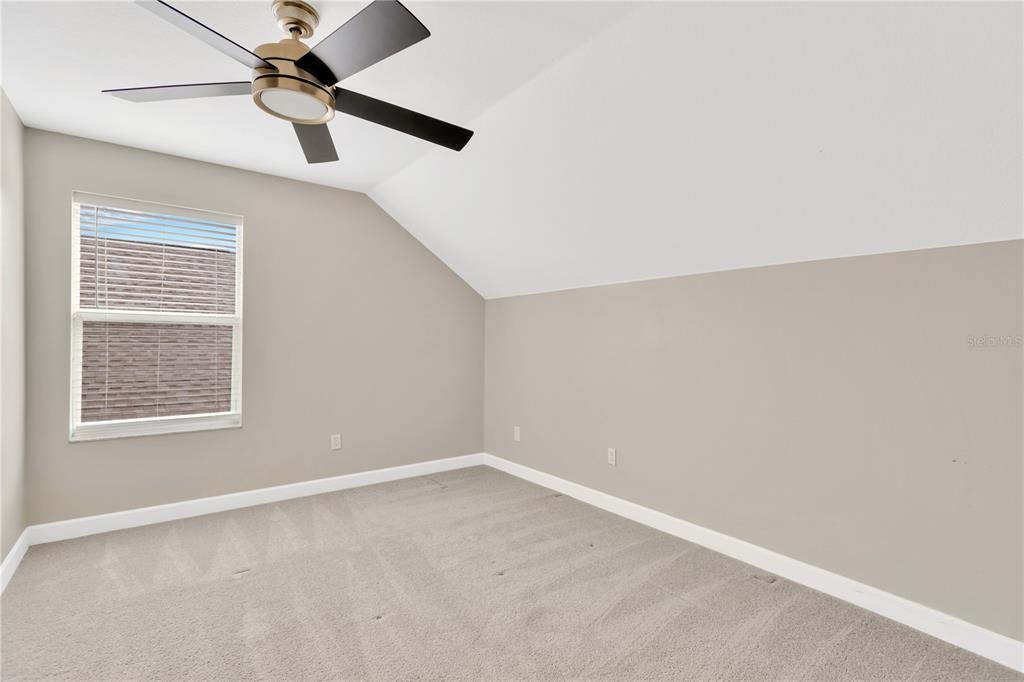 10814 Newbridge Drive Riverview, FL 33579 - Photo 19 of 44 an empty room with a window and a fan
