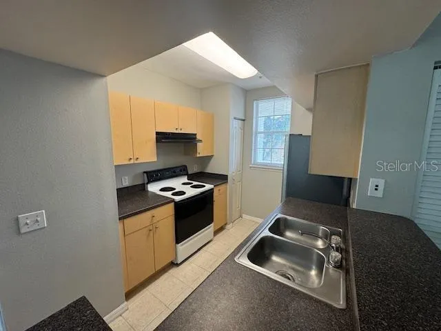 a kitchen that has a sink and a stove