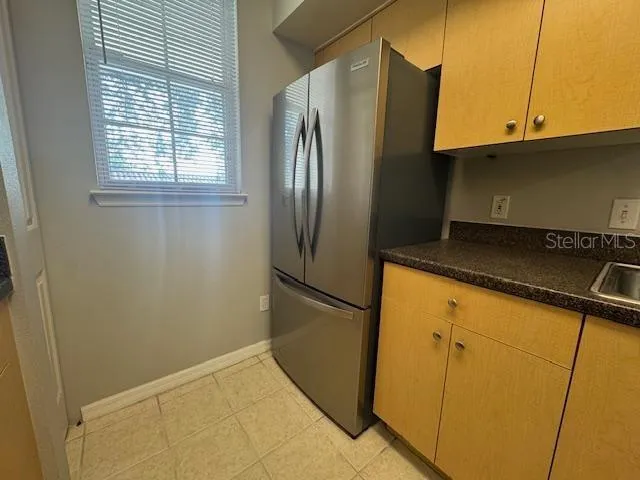 a metallic refrigerator freezer sitting in a kitchen
