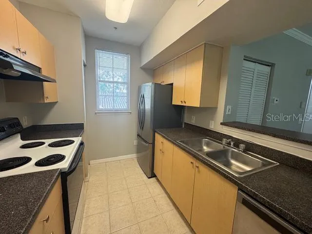 a kitchen with a sink stove and cabinets