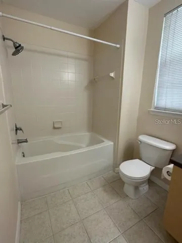 a bathroom with a toilet and a bathtub