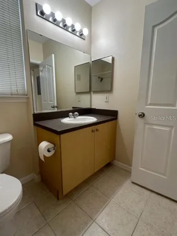 a bathroom with a sink a toilet and mirror
