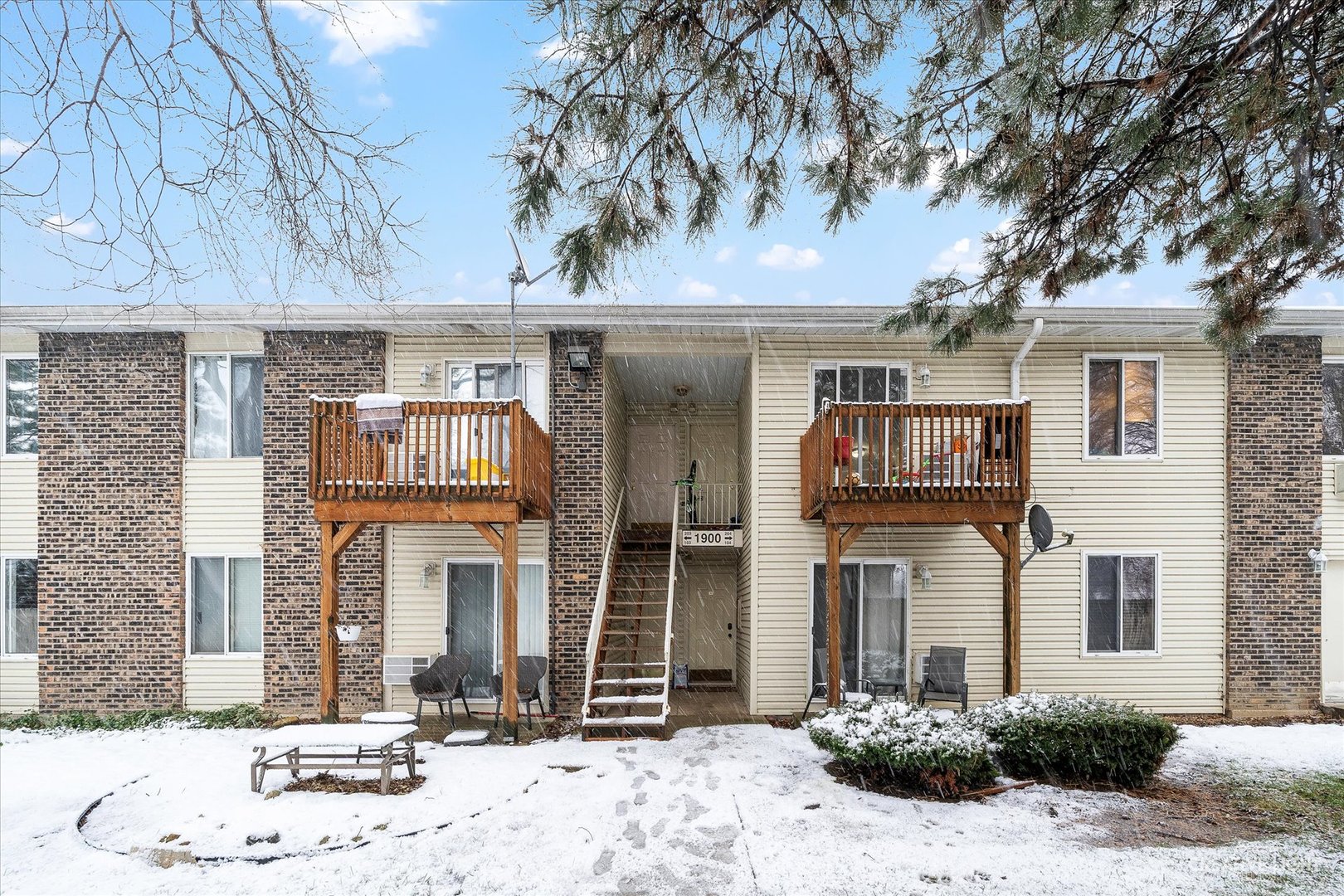 1900 Light Road, Unit 204 Oswego, IL 60543 - Photo 1 of 15 a front view of a house with a yard