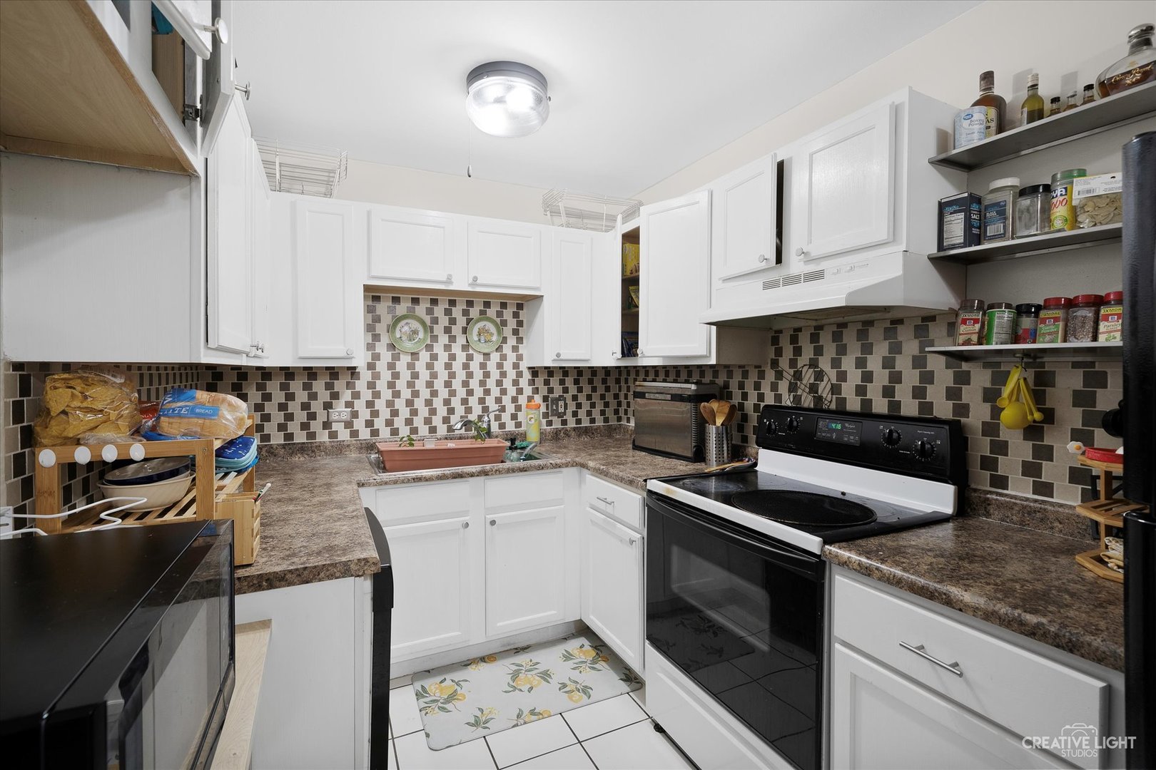 1900 Light Road, Unit 204 Oswego, IL 60543 - Photo 6 of 15 a kitchen with a sink stove and cabinets