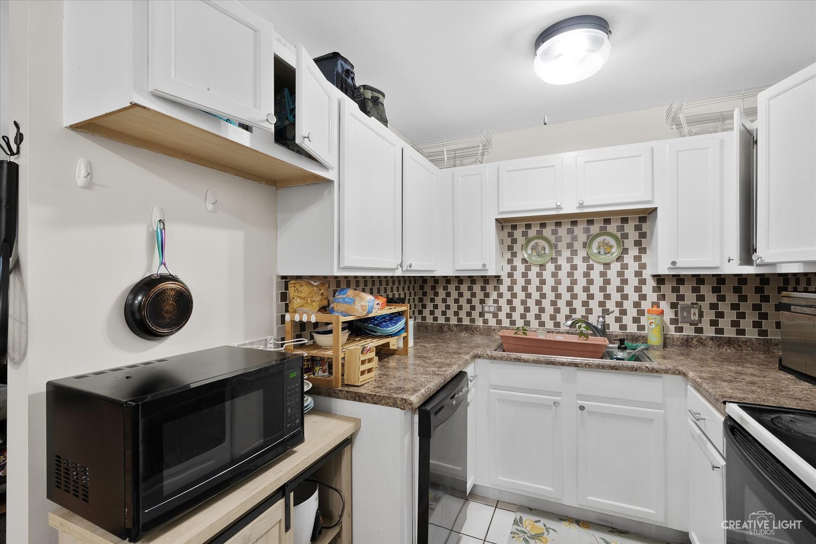 1900 Light Road, Unit 204 Oswego, IL 60543 - Photo 7 of 15 a kitchen with a stove and a sink