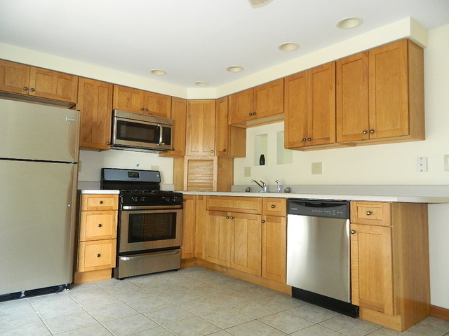 1416 Hainesville Road Round Lake Beach, IL 60073 - Photo 2 of 7 a kitchen with stainless steel appliances granite countertop a refrigerator stove a sink and dishwasher