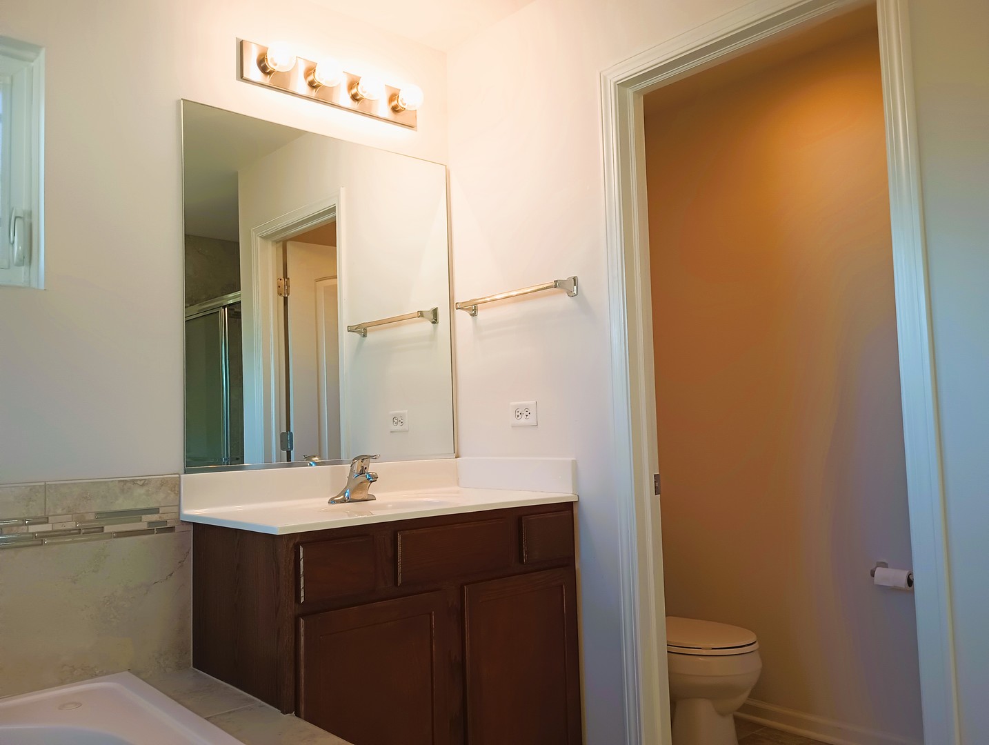 777 West Mystic Lane Romeoville, IL 60446 - Photo 21 of 35 a bathroom with a sink a toilet and a mirror