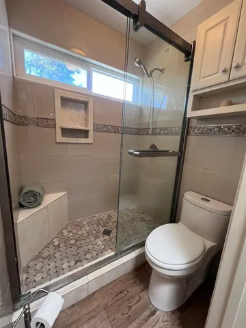 a white toilet sitting next to a bathroom sink