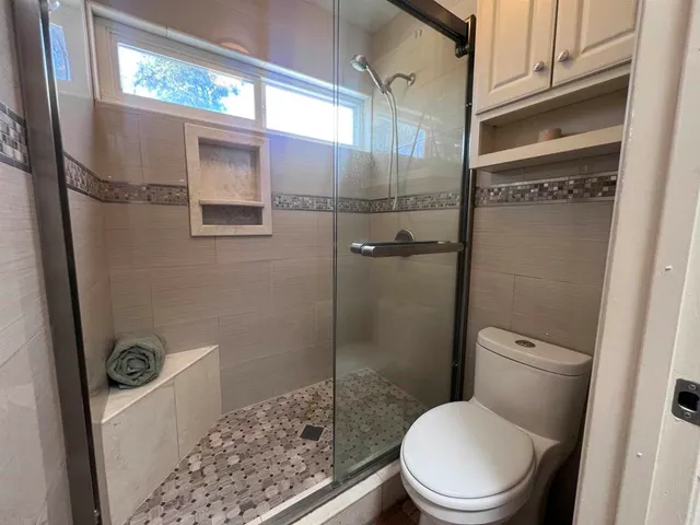 a white toilet sitting next to a bathroom sink