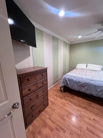 a bedroom with a bed and a television