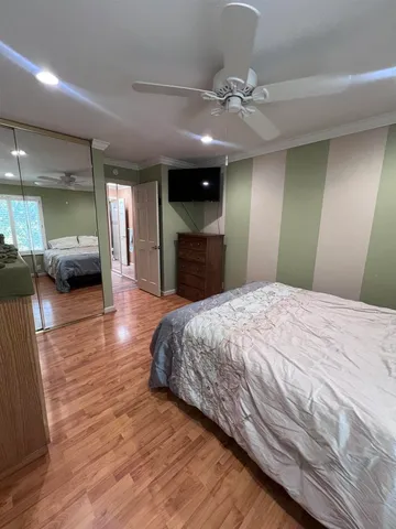 a spacious bedroom with a large bed and a chandelier