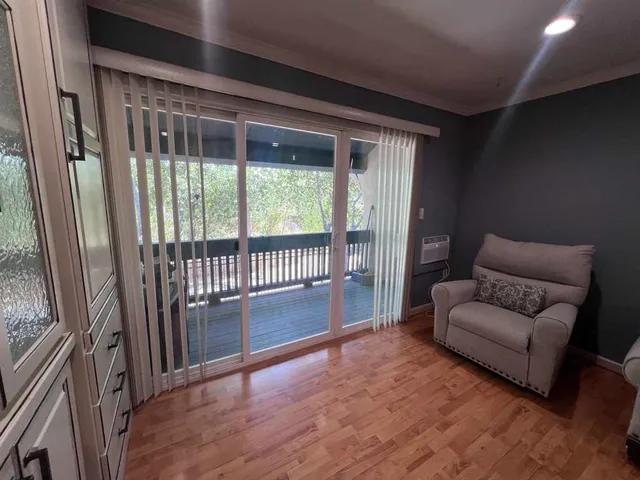 a living room with furniture and a floor to ceiling window