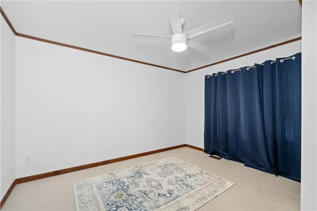 a view of a room with wooden floor and a window