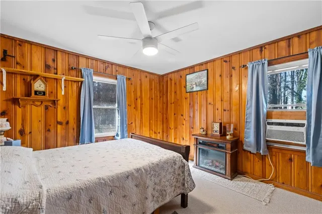 a bedroom with a bed and dresser with mirror