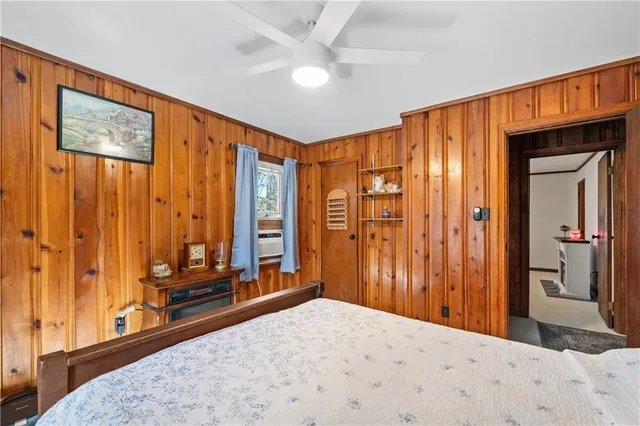 a bedroom with a bed and a chandelier