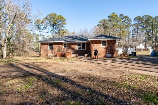 a view of backyard with a table and chairs