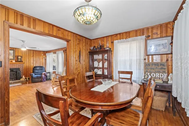 a dining room with furniture a chandelier and wooden floor