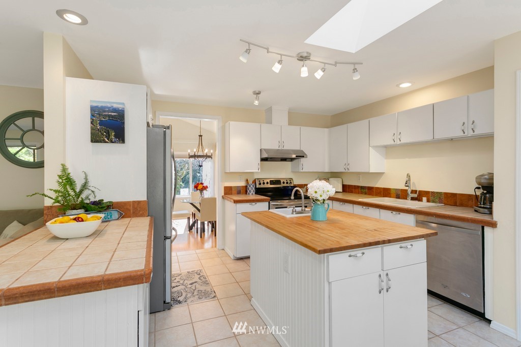 101 North Lake Roesiger Road Snohomish, WA 98290 - Photo 12 of 39 a kitchen with a sink a stove and chairs