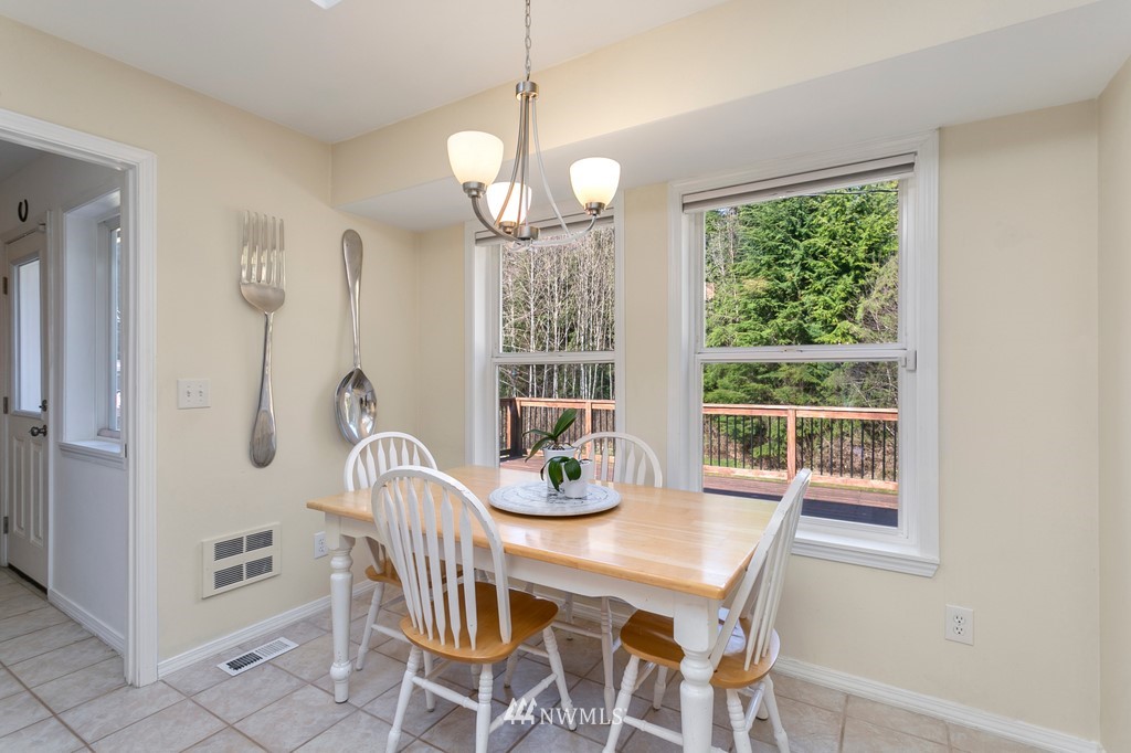 101 North Lake Roesiger Road Snohomish, WA 98290 - Photo 13 of 39 a dining room with furniture a chandelier and window