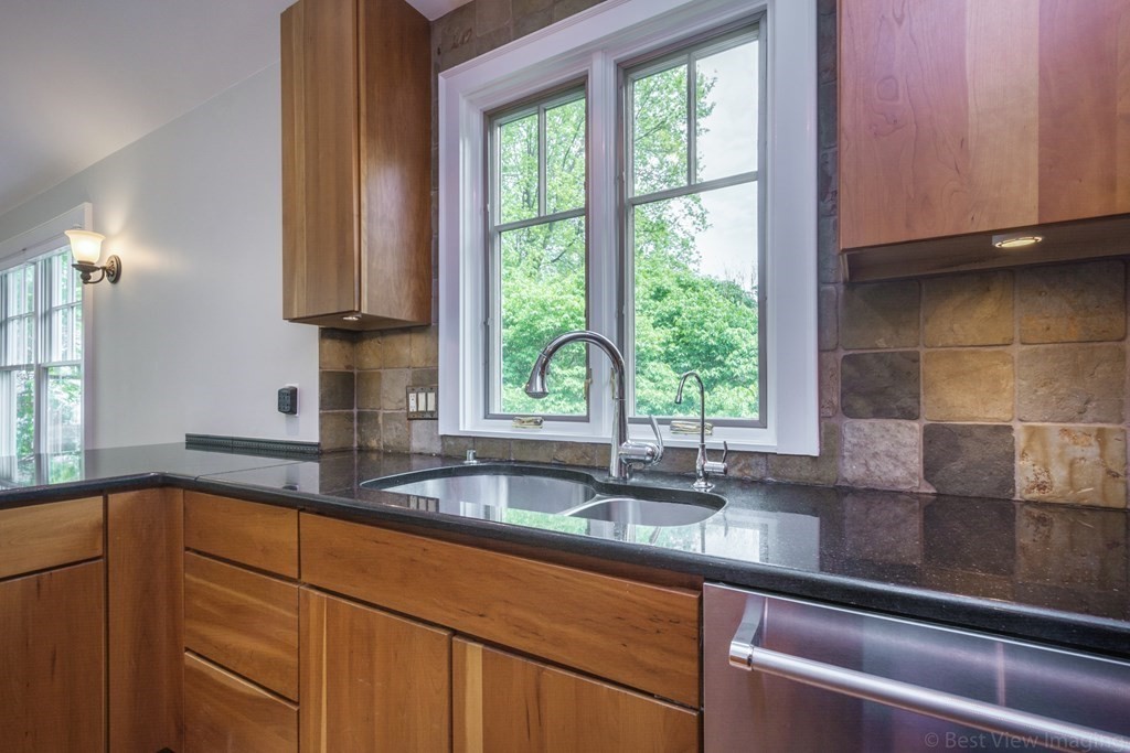 10 Chapin Road Newton, MA 02459 - Photo 13 of 35 a kitchen with granite countertop a sink a counter space and cabinets