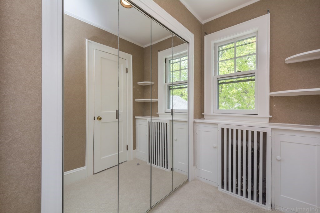 10 Chapin Road Newton, MA 02459 - Photo 23 of 35 a view of a hallway with windows and chandelier