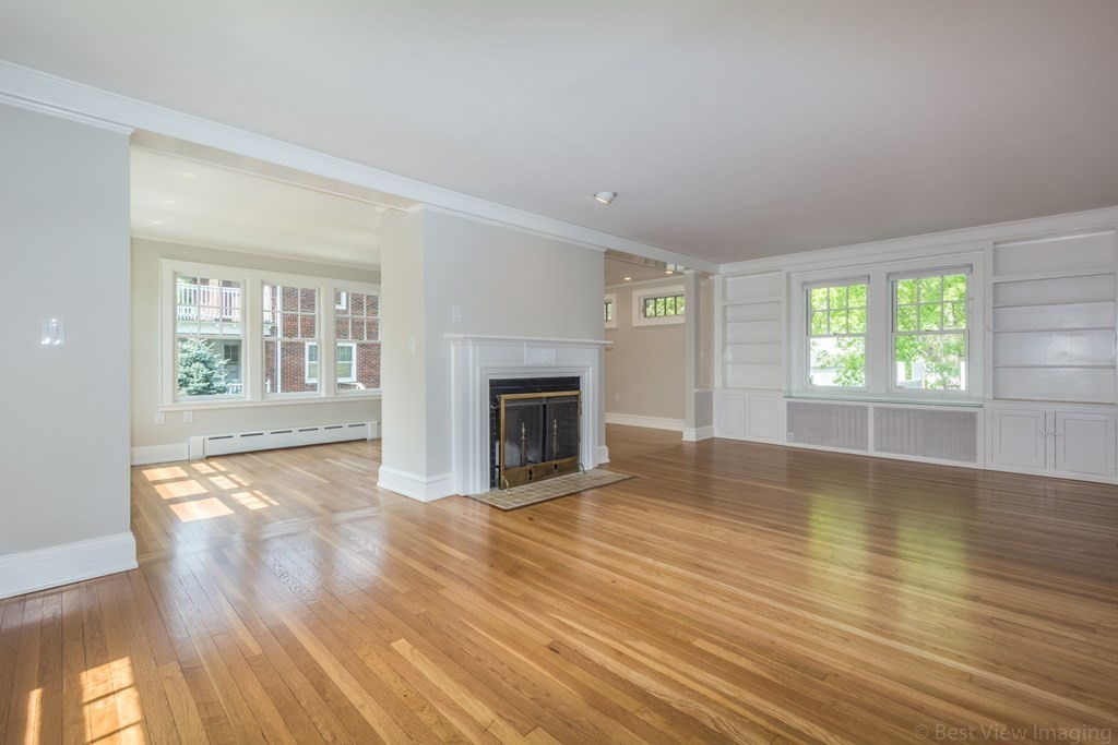 10 Chapin Road Newton, MA 02459 - Photo 5 of 35 an empty room with wooden floor and fireplace