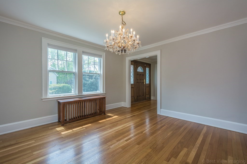 10 Chapin Road Newton, MA 02459 - Photo 9 of 35 a view of an empty room with wooden floor and a window