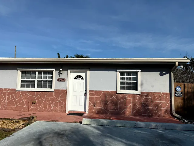 a view of a house with wooden fence