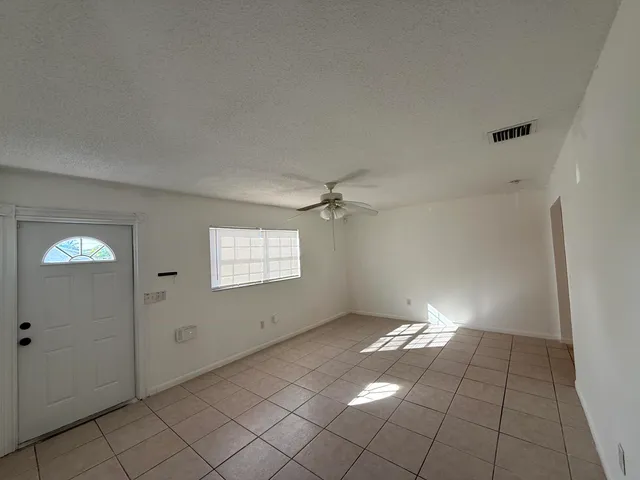 an empty room with windows and closet