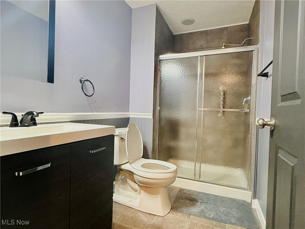 155 Stone Ridge Way Berea, OH 44017 - Photo 29 of 32 Bathroom with vanity, toilet, a shower stall, and tile patterned flooring