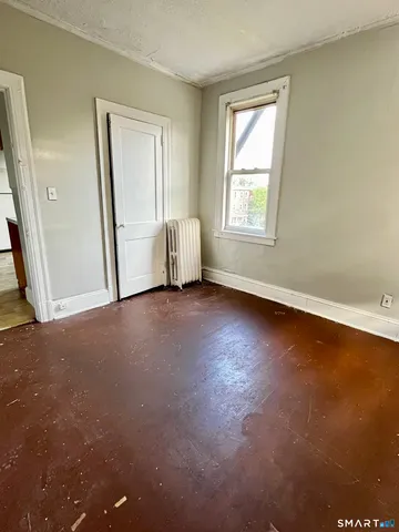 a kitchen with granite countertop a stove and a wooden cabinets