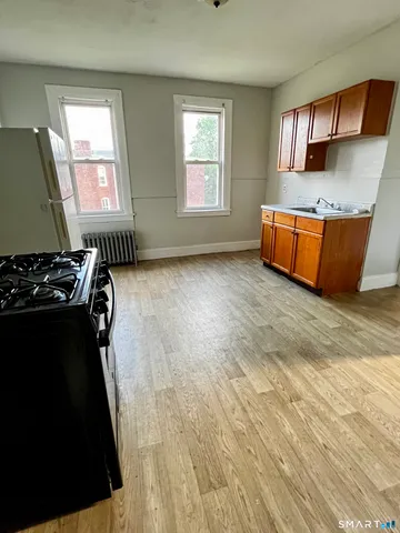 a view of an empty room with a fireplace