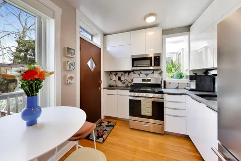 a kitchen with stainless steel appliances a stove a sink a microwave and a refrigerator