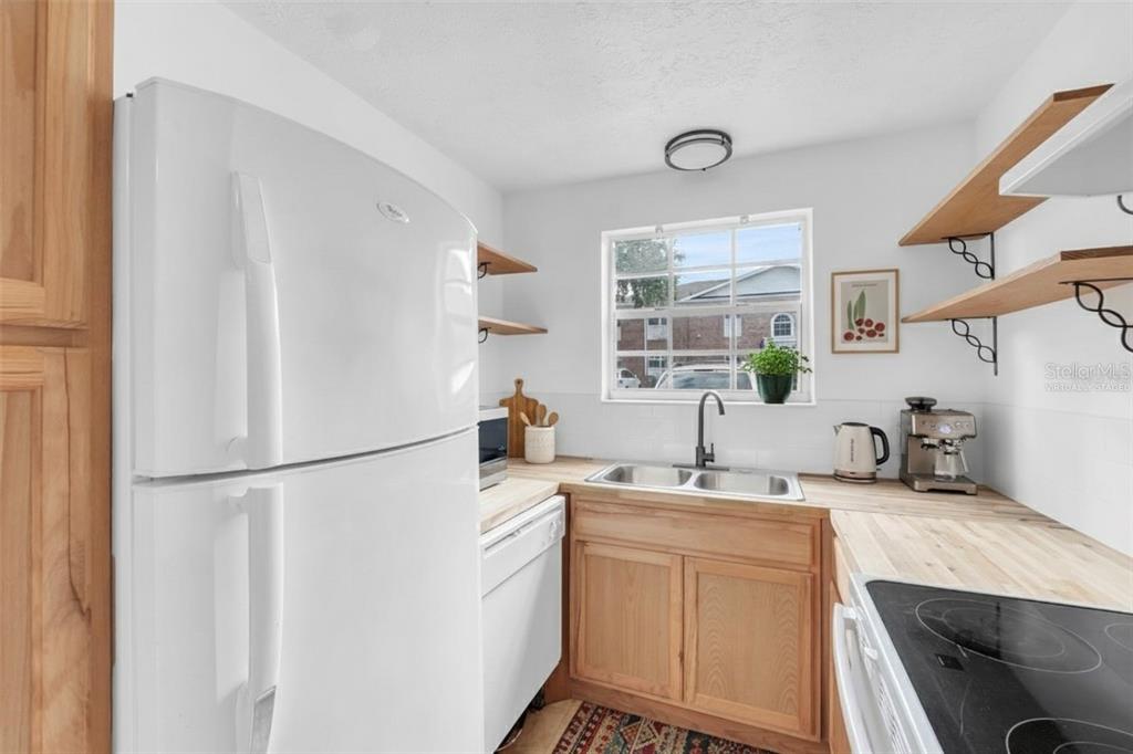4212 Lake Underhill Road, Unit A Orlando, FL 32803 - Photo 11 of 35 a kitchen with a sink appliances and cabinets