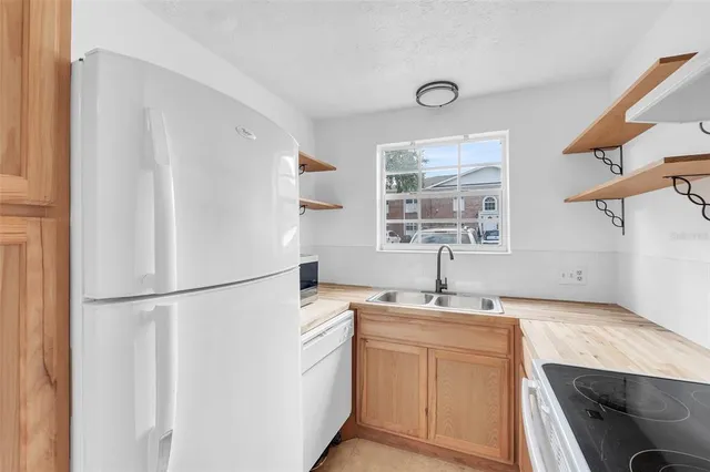 a kitchen with appliances cabinets and a sink