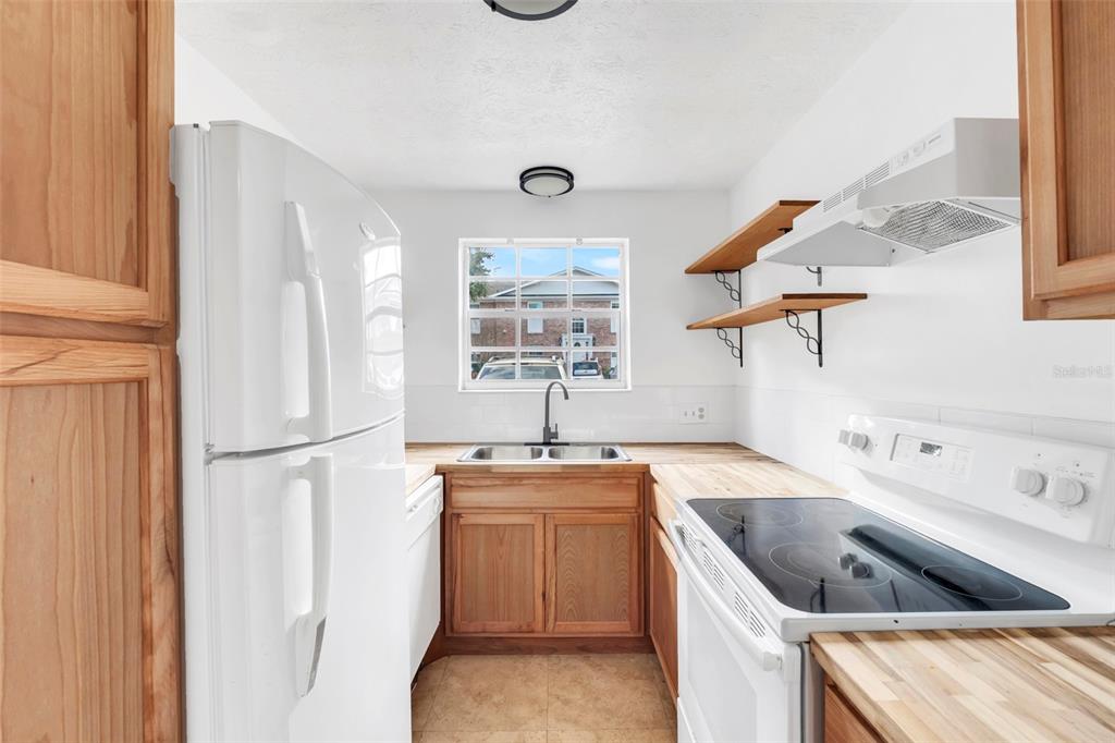 4212 Lake Underhill Road, Unit A Orlando, FL 32803 - Photo 14 of 35 a kitchen with a sink cabinets and window