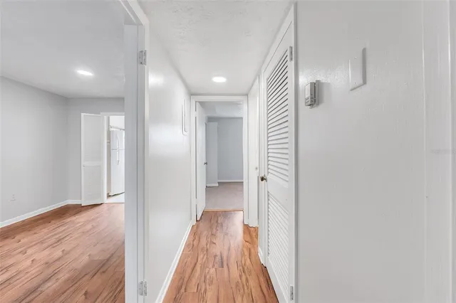 a view of a hallway with wooden floor