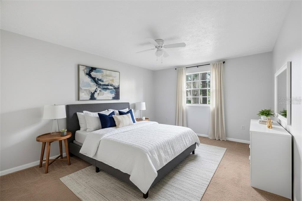 4212 Lake Underhill Road, Unit A Orlando, FL 32803 - Photo 16 of 35 a bedroom with a bed and wooden floor