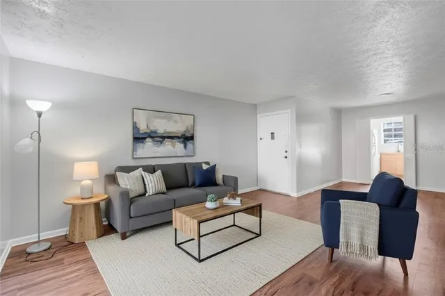 a living room with furniture and a lamp