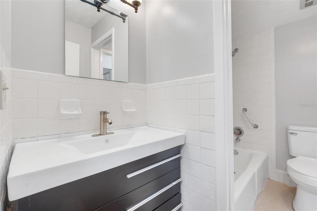 4212 Lake Underhill Road, Unit A Orlando, FL 32803 - Photo 22 of 35 a bathroom with a sink a toilet and shower