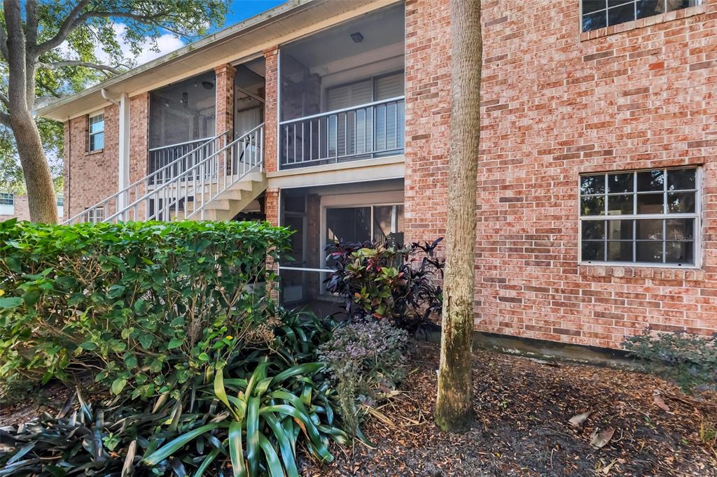 4212 Lake Underhill Road, Unit A Orlando, FL 32803 - Photo 30 of 35 a view of a brick house with plants and large tree