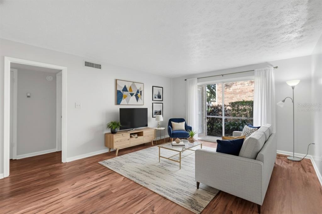 4212 Lake Underhill Road, Unit A Orlando, FL 32803 - Photo 6 of 35 a living room with furniture and a flat screen tv