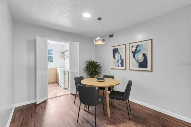 a view of a dining room with furniture window and wooden floor