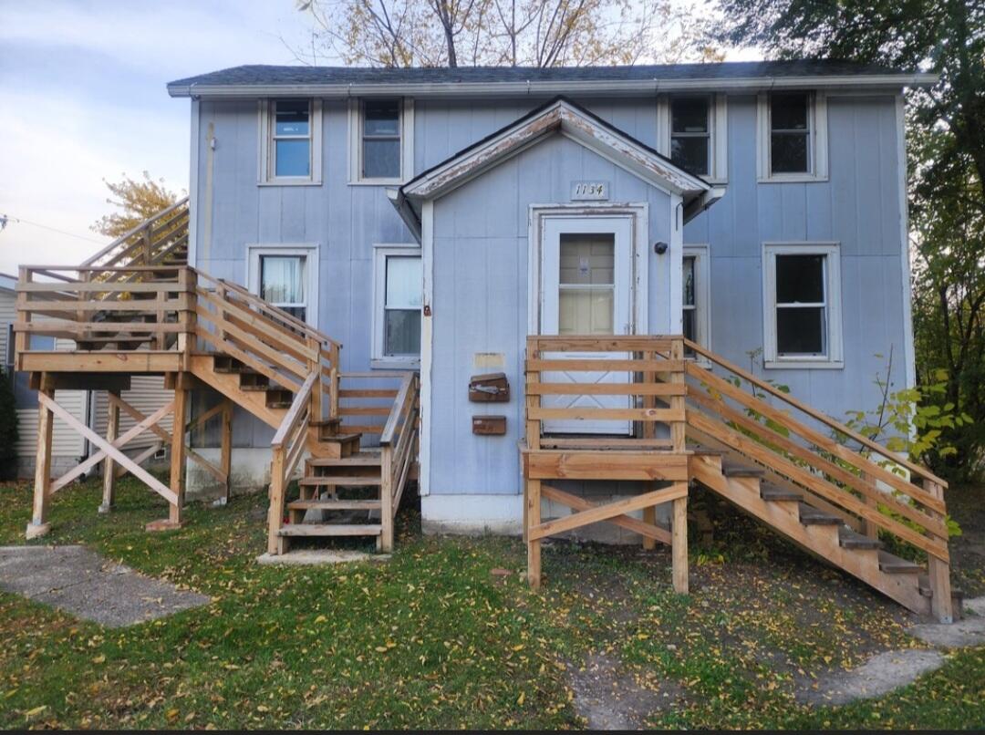 a backyard of a house with wooden fence and deck
