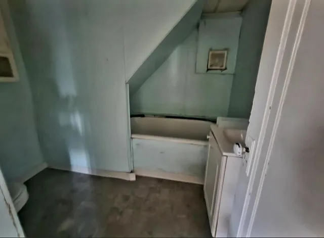 a view of a livingroom with wooden floor and a window