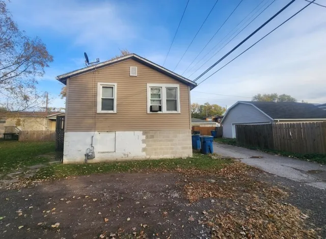 a view of a pathway of a house with a yard