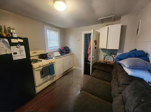 a bed sitting in a bedroom next to a window