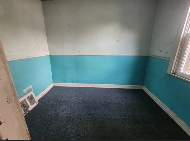 a view of an empty room and a window