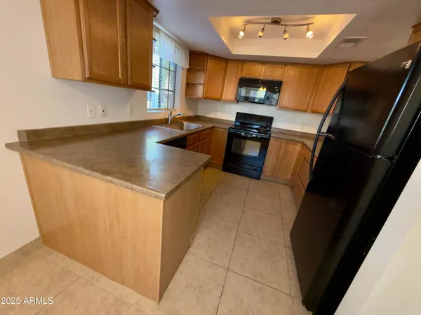 a kitchen with a sink cabinets and a window