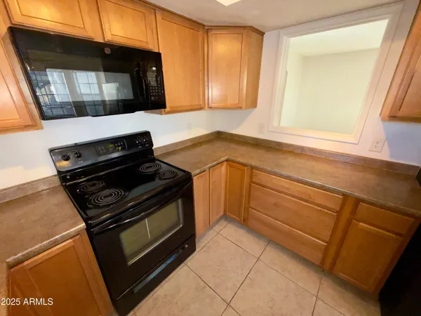 a view of a room with wooden floor and cabinet